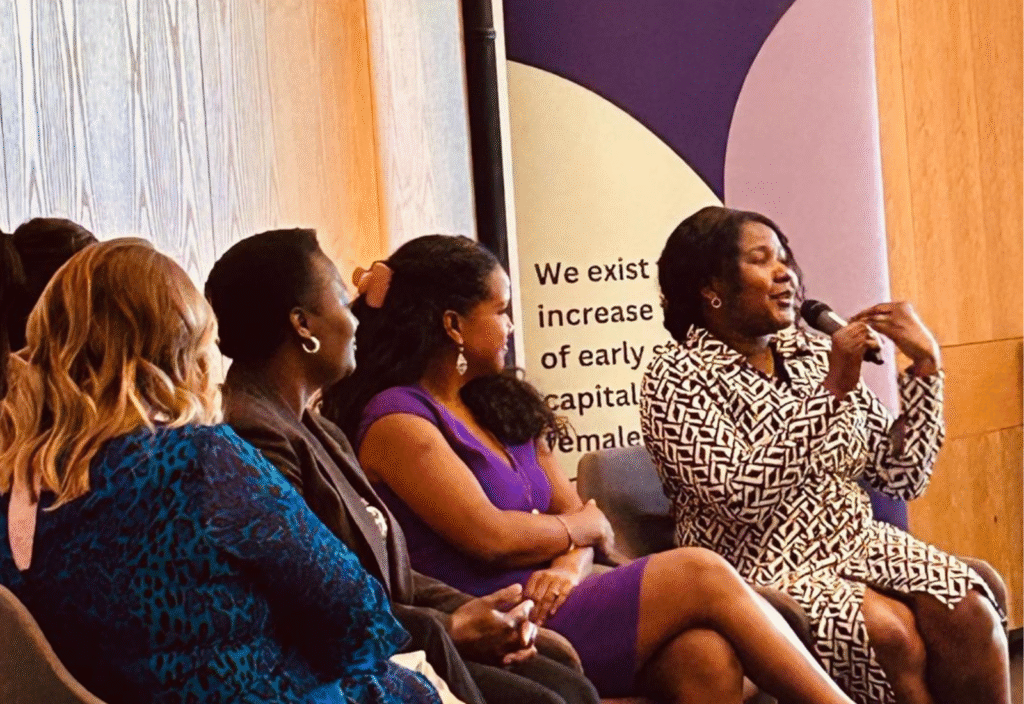 Lady speaking on a microphone at a Lifted Ventures event